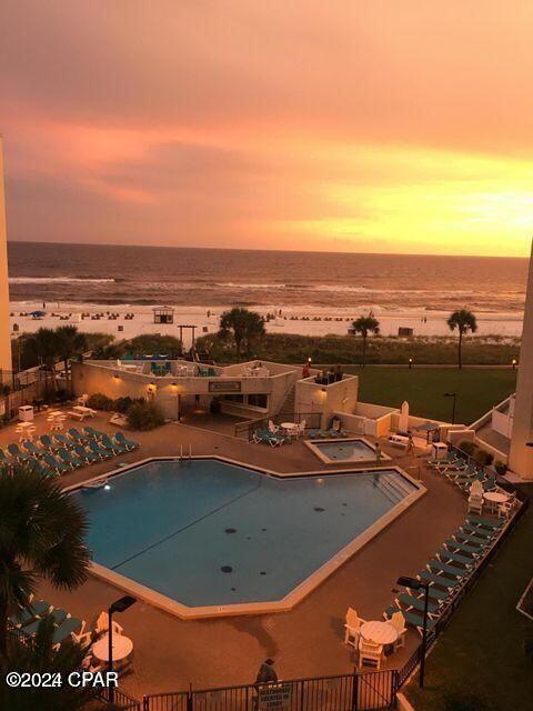 pool at dusk with a water view