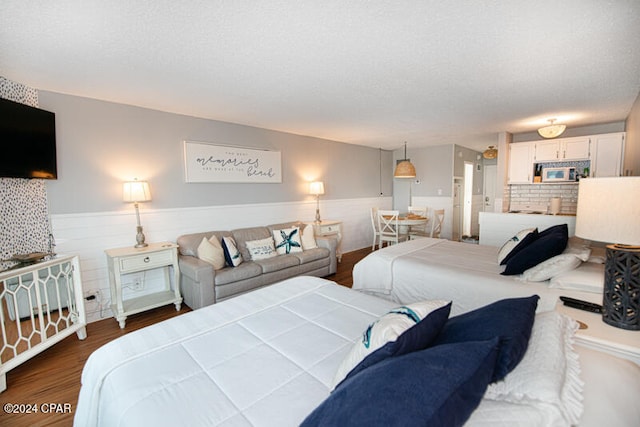 bedroom featuring a textured ceiling and dark wood-type flooring