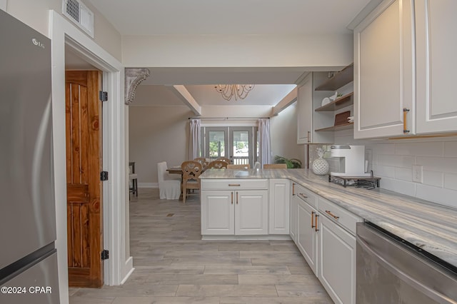 kitchen with stainless steel appliances, a peninsula, visible vents, french doors, and open shelves