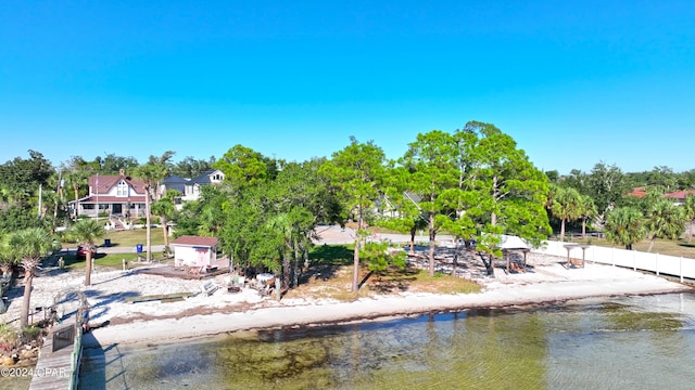 view of home's community featuring a water view and fence