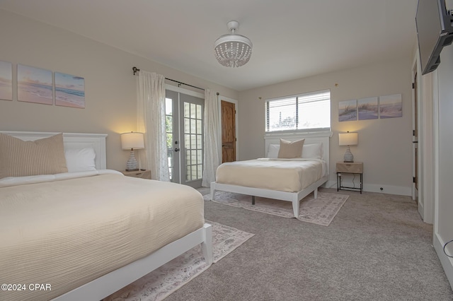 bedroom featuring access to outside, french doors, carpet flooring, and baseboards