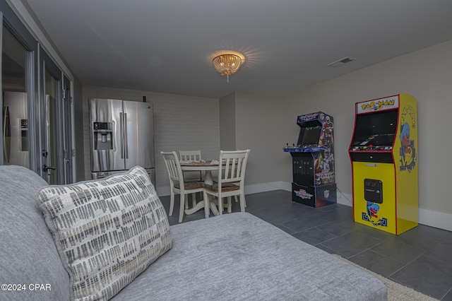 interior space with baseboards, visible vents, and tile patterned floors