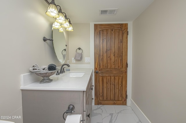 bathroom featuring marble finish floor, baseboards, visible vents, and vanity