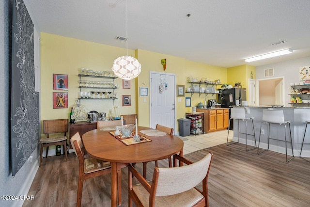 dining room with light wood-type flooring