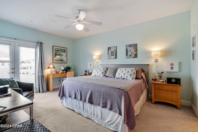 bedroom featuring access to exterior, french doors, light colored carpet, and ceiling fan