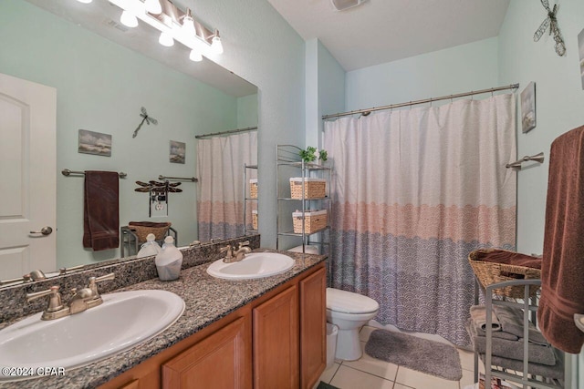 bathroom with tile patterned floors, vanity, and toilet