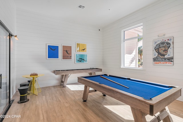 game room with wood walls, light hardwood / wood-style floors, and pool table