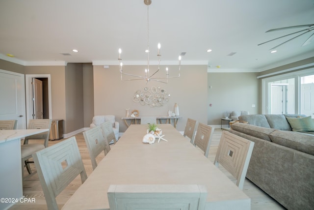 111 31st St Unit A & B, Mexico Beach, FL 32456 - dining space with ornamental molding, a chandelier, and light hardwood / wood-style floors