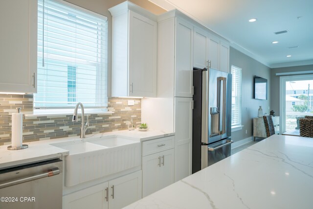 111 31st St Unit A & B, Mexico Beach, FL 32456 - kitchen featuring light stone counters, white cabinetry, and appliances with stainless steel finishes