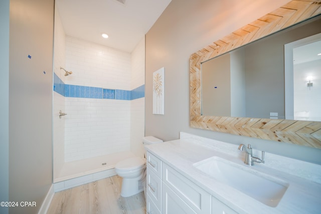 111 31st St Unit A & B, Mexico Beach, FL 32456 - bathroom featuring hardwood / wood-style flooring, vanity, a tile shower, and toilet