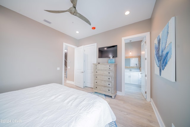 111 31st St Unit A & B, Mexico Beach, FL 32456 - bedroom with ceiling fan, connected bathroom, and light hardwood / wood-style floors