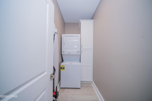 111 31st St Unit A & B, Mexico Beach, FL 32456 - laundry room featuring stacked washing maching and dryer and light hardwood / wood-style flooring