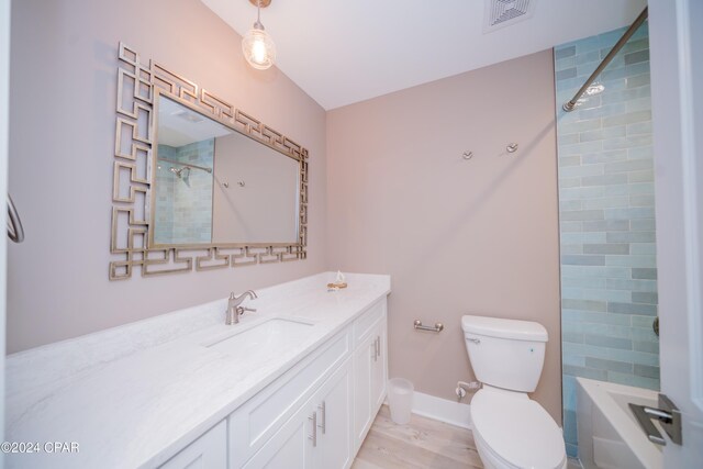 111 31st St Unit A & B, Mexico Beach, FL 32456 - full bathroom with bathtub / shower combination, vanity, toilet, and hardwood / wood-style floors