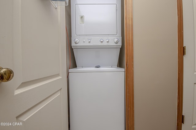 clothes washing area featuring stacked washer / dryer