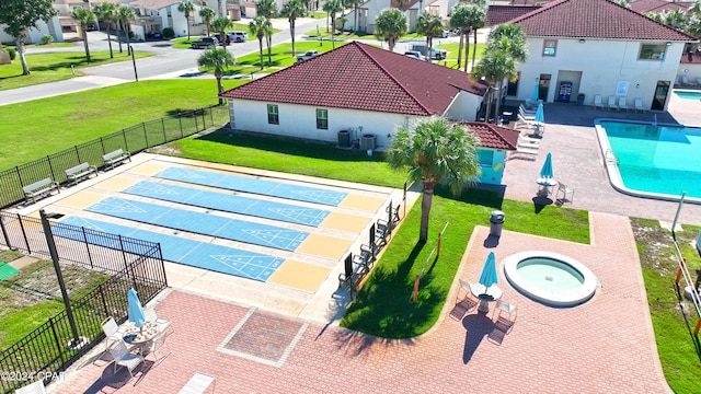 view of swimming pool with a lawn and central AC unit