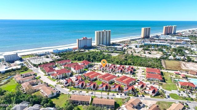 birds eye view of property featuring a water view and a beach view