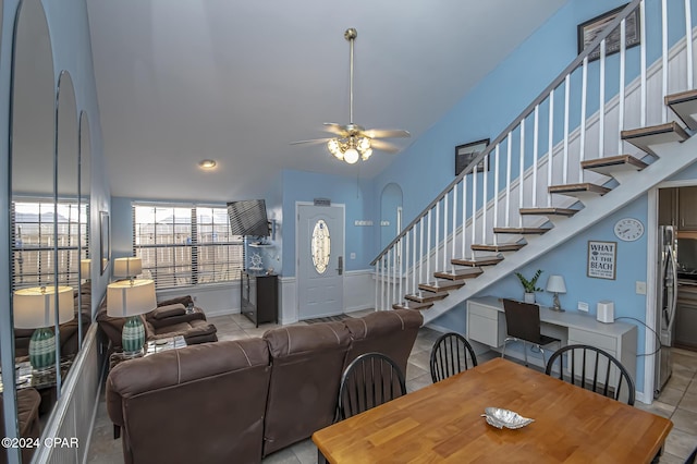 dining area with light tile patterned floors, ceiling fan, and lofted ceiling