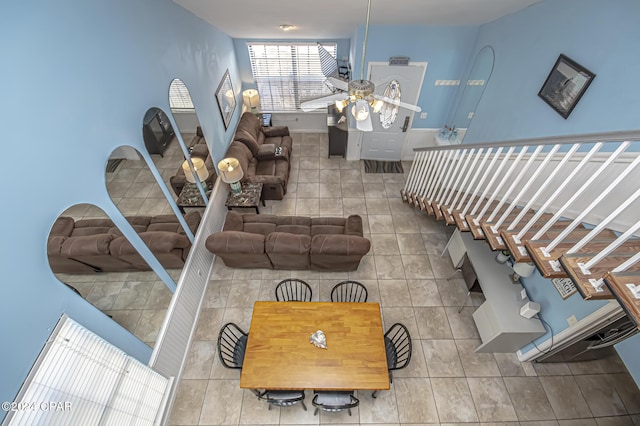 living room featuring ceiling fan and tile patterned flooring