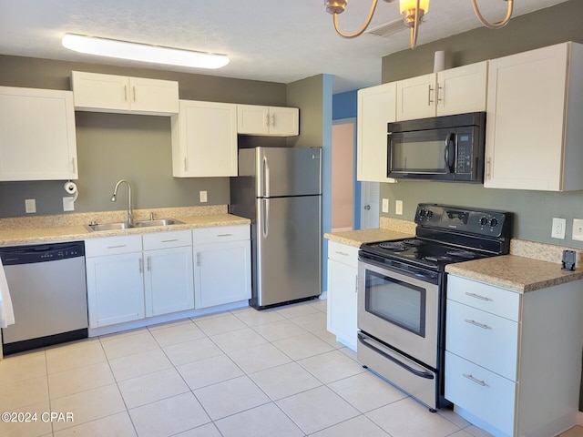 kitchen featuring white cabinetry, sink, a textured ceiling, and appliances with stainless steel finishes