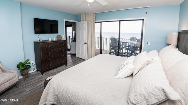 bedroom featuring access to outside, ceiling fan, and dark wood-type flooring