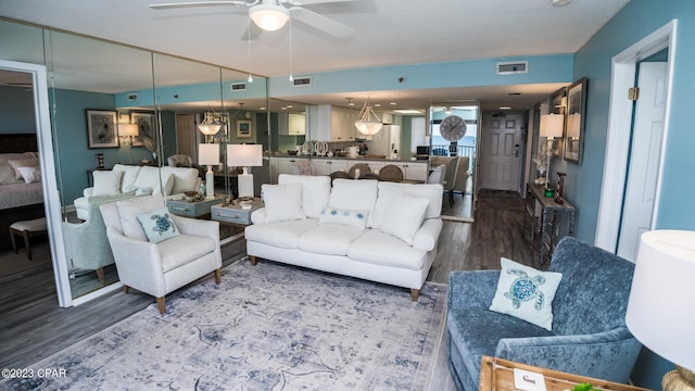 living room with ceiling fan and hardwood / wood-style flooring