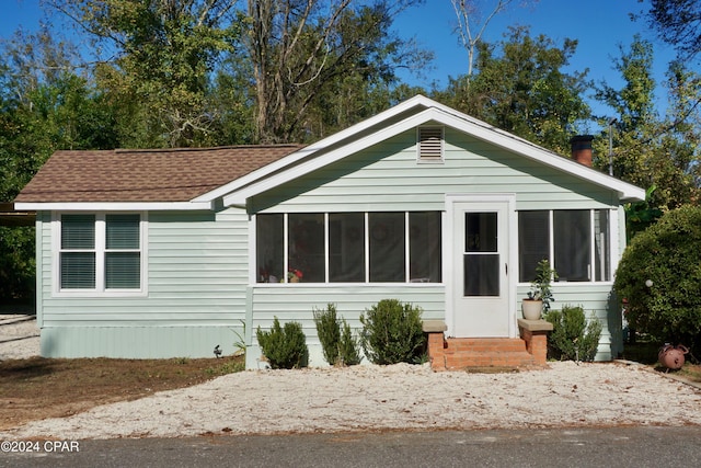 view of front of house with a sunroom