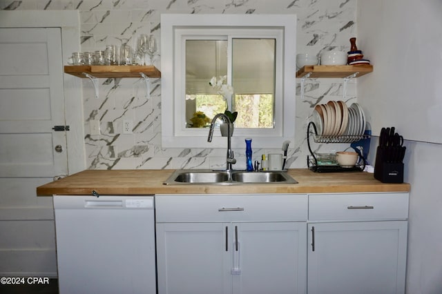 bar with white cabinetry, sink, white dishwasher, and wood counters