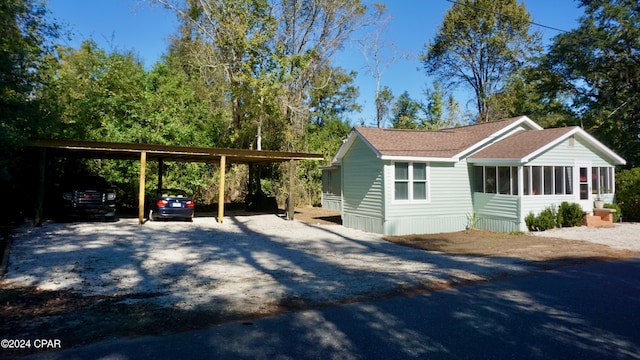 exterior space with a carport and a sunroom