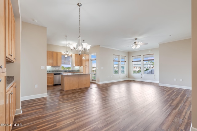 kitchen featuring a center island, hanging light fixtures, dark wood-type flooring, stainless steel dishwasher, and ceiling fan with notable chandelier