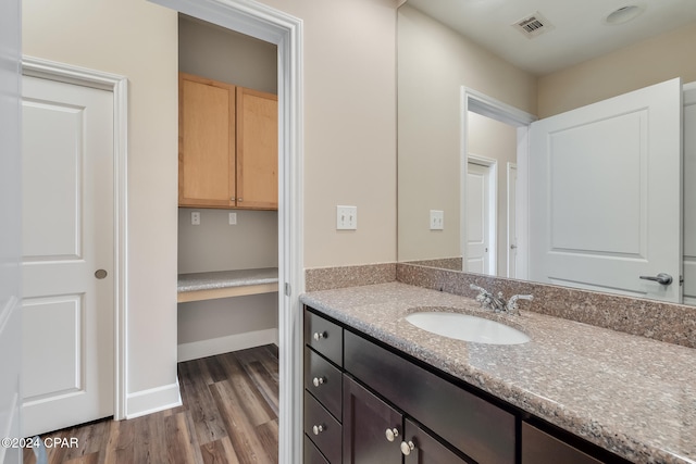 bathroom with hardwood / wood-style floors and vanity