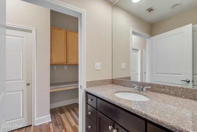 bathroom featuring vanity and hardwood / wood-style flooring