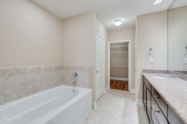 bathroom with vanity and a tub