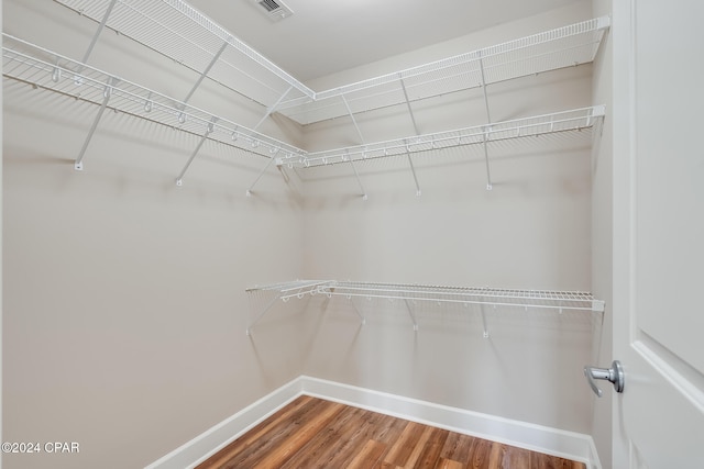 spacious closet featuring hardwood / wood-style floors