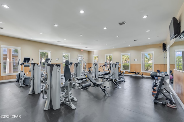 exercise room featuring wood walls