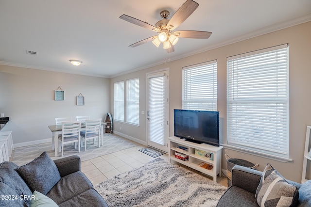 living room featuring a wealth of natural light, crown molding, and ceiling fan