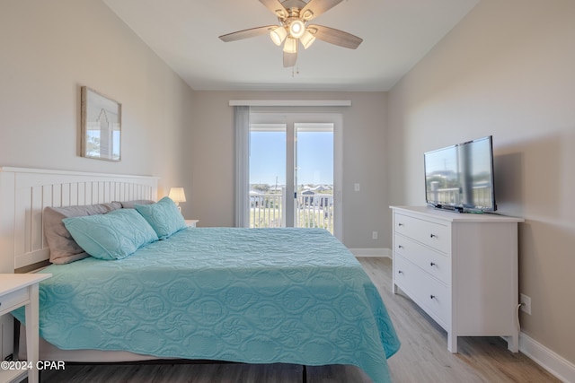 bedroom featuring access to outside, ceiling fan, and light hardwood / wood-style flooring