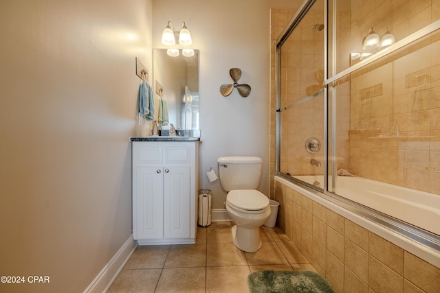 full bathroom featuring shower / bath combination with glass door, tile patterned flooring, vanity, and toilet