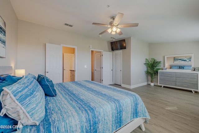 bedroom with hardwood / wood-style floors and ceiling fan