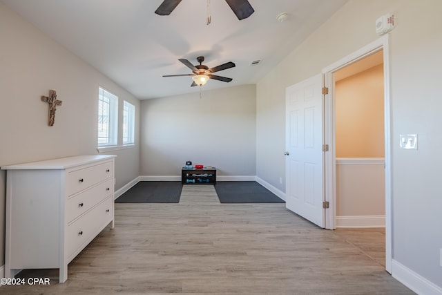 interior space featuring ceiling fan, light hardwood / wood-style floors, and vaulted ceiling