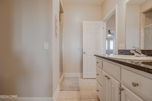 bathroom featuring tile patterned flooring, ceiling fan, an enclosed shower, and vanity