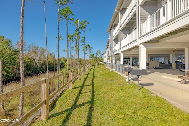 view of yard with a balcony and a patio