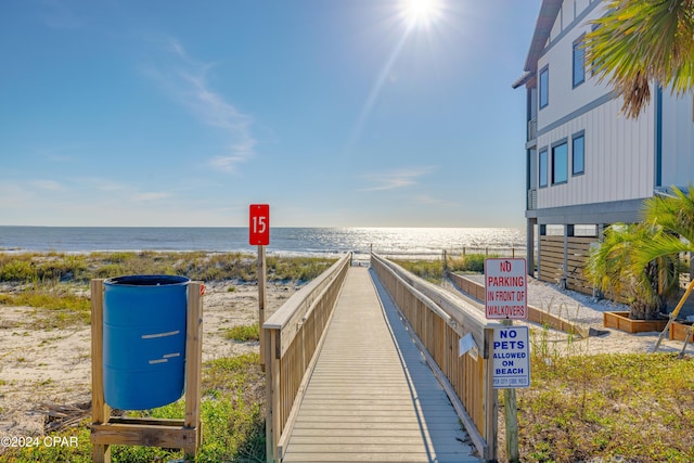 view of home's community with a water view and a view of the beach