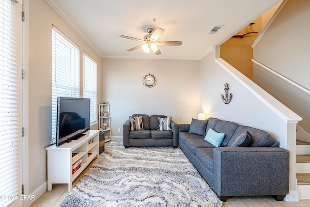 tiled living room with ceiling fan and ornamental molding