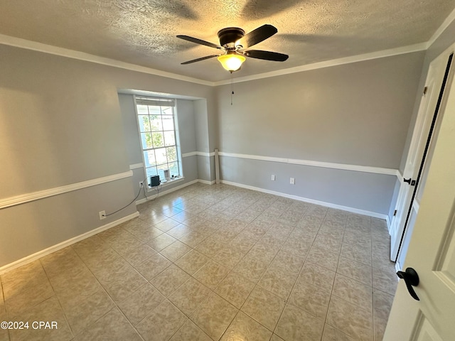 tiled spare room featuring ceiling fan, ornamental molding, and a textured ceiling