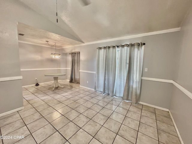 interior space featuring lofted ceiling, a textured ceiling, and ornamental molding