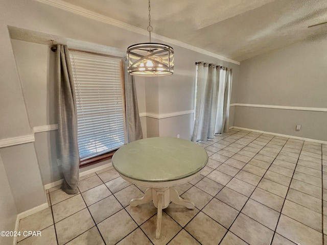 unfurnished dining area with crown molding, light tile patterned floors, vaulted ceiling, and an inviting chandelier