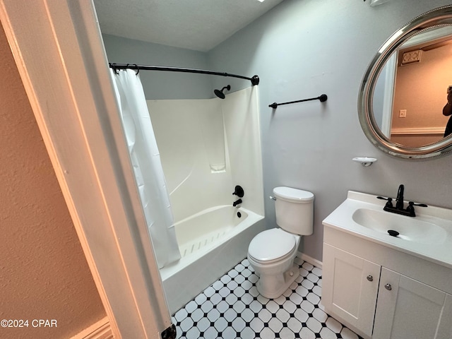 full bathroom featuring vanity, shower / bath combo, tile patterned floors, toilet, and a textured ceiling