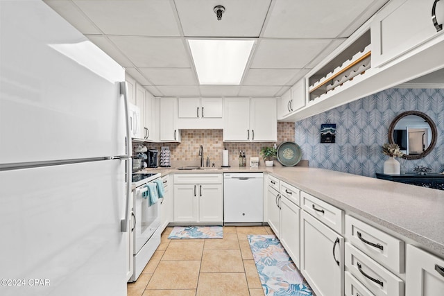6201 Thomas Dr Unit 1606, Panama City Beach, FL 32408 - kitchen with white appliances, a sink, white cabinetry, and a paneled ceiling