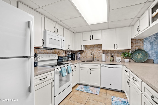 6201 Thomas Dr Unit 1606, Panama City Beach, FL 32408 - kitchen featuring white appliances, a sink, light countertops, a paneled ceiling, and white cabinetry