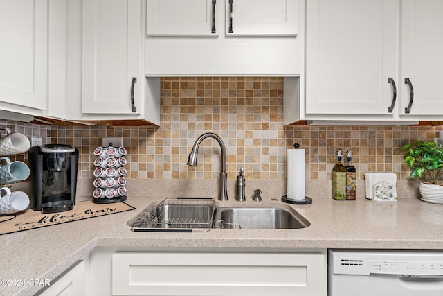 6201 Thomas Dr Unit 1606, Panama City Beach, FL 32408 - kitchen featuring white dishwasher, a sink, white cabinets, backsplash, and light stone counters
